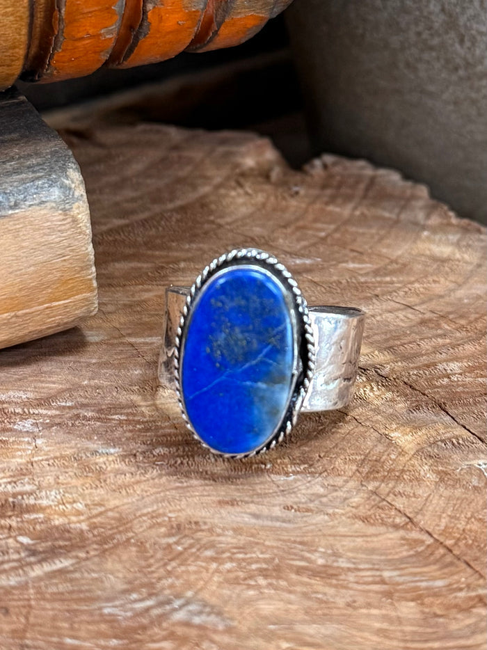 Adjustable silver-plated ring with oval blue lapis stone and beaded border