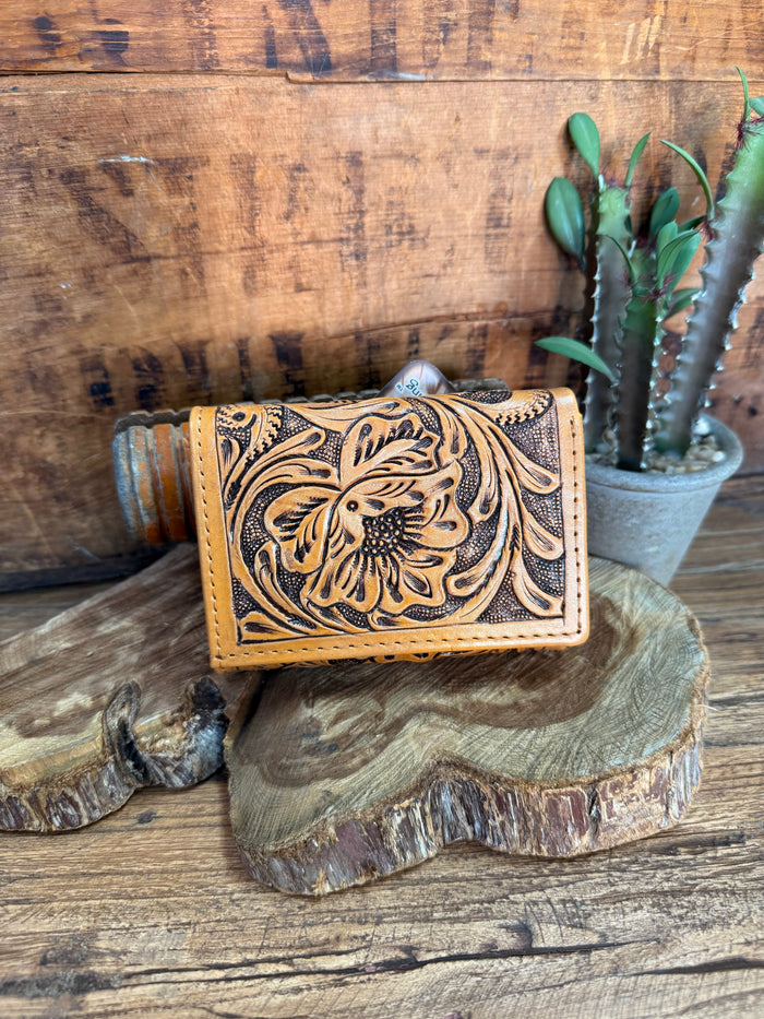 Tan leather wallet with ornate floral tooled front and snap closure