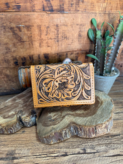 Tan leather wallet with ornate floral tooled front and snap closure