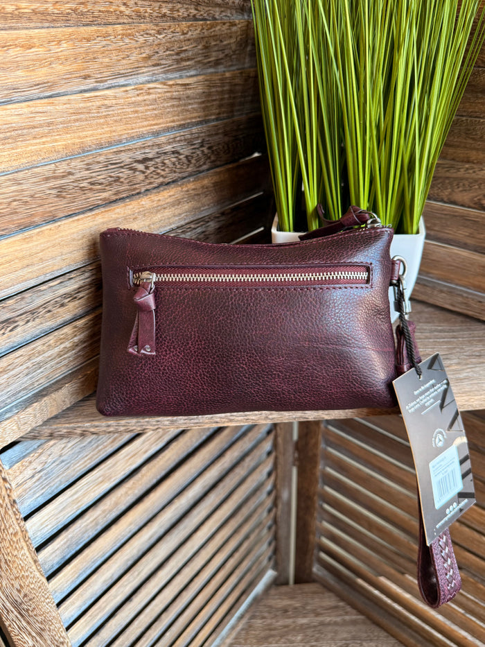 Plum mini wristlet bag with zip top, wrist strap, and metal zipper pull