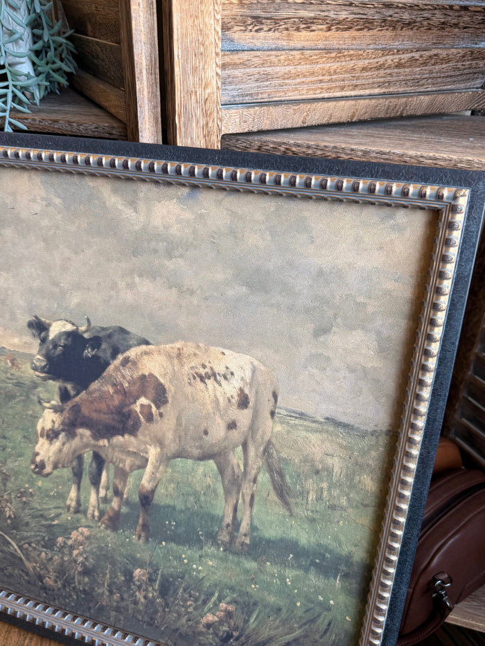 Close-up of framed prairie artwork border with blue beaded trim and grazing cows