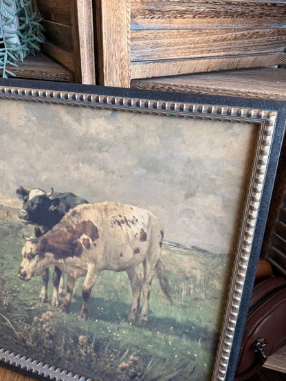 Close-up of framed prairie artwork border with blue beaded trim and grazing cows
