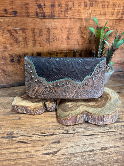 Dark blue leather wallet with embossed floral tooling and rhinestone-studded trim