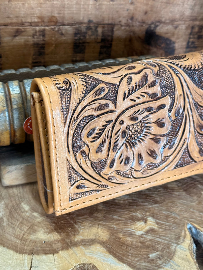 Tan cowhide wallet front with carved floral embossing and contrast stitching