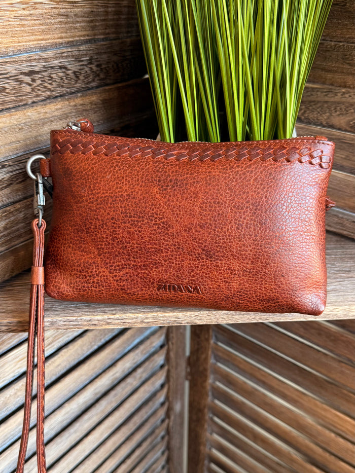 Rusty brown mini wristlet bag with textured leather look, wrist strap, zip top