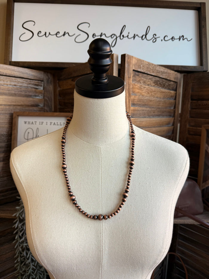 Triple pearl stack necklace with silver-tone beaded chain, layered three-row design