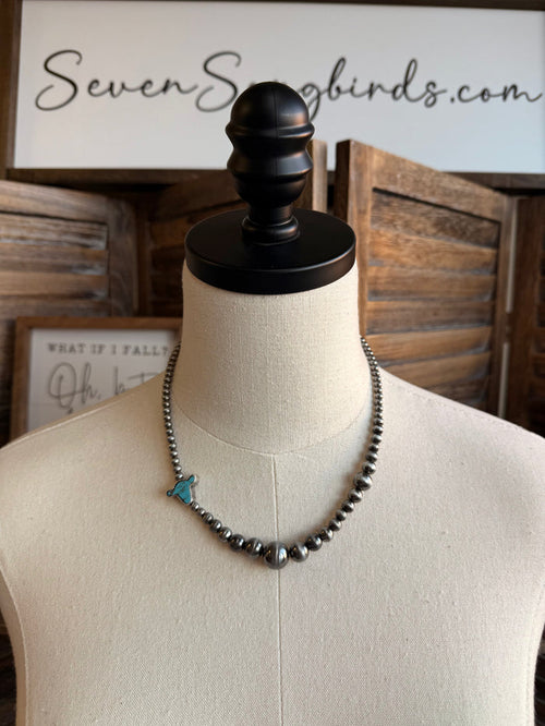 Silver-tone beaded necklace with turquoise cowhead charm and small drops
