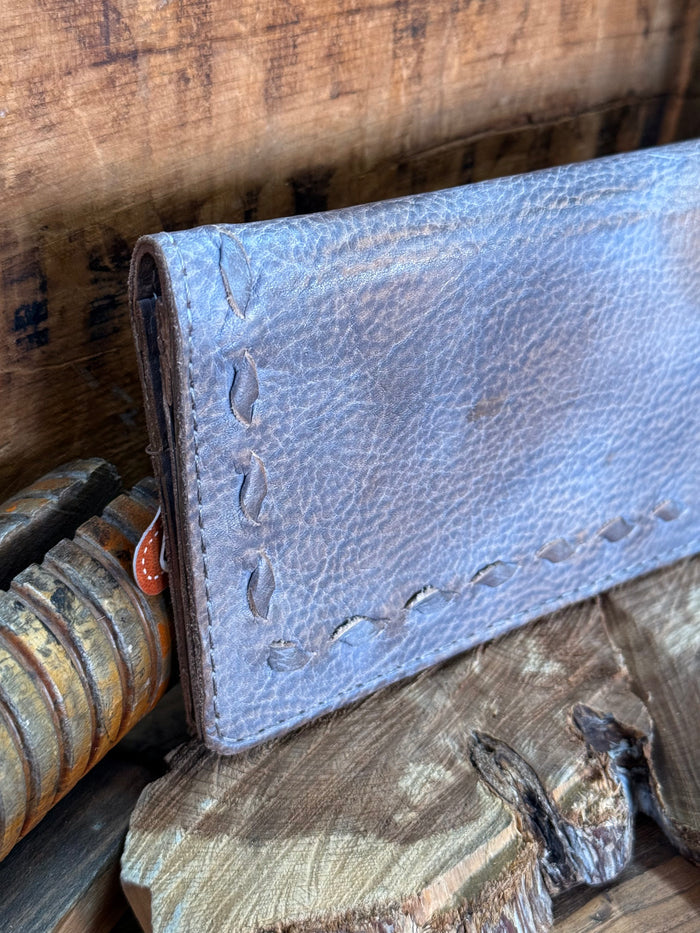 Gray cowhide checkbook wallet side view, embossed pebble grain and decorative stitching