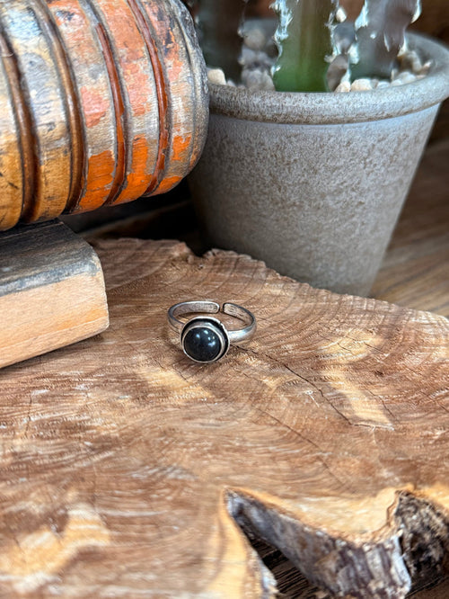 Adjustable silver-toned ring with round dark stone cabochon in bezel setting