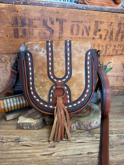 Brown cowhide flap crossbody bag with white diamond stitching and long fringe tassel