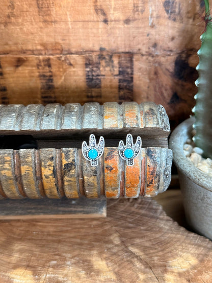 Cactus stud earrings with turquoise crystal centers in silver-tone prongs
