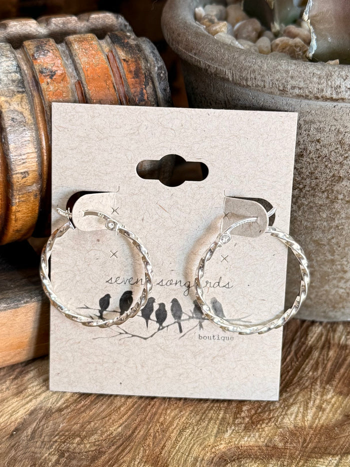 Large twisted-rope round hoop earrings with dangling clasp, shown on product card