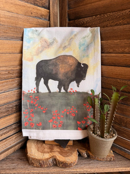 Tea towel with watercolor buffalo and red poppy pattern across the bottom border
