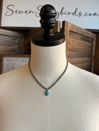 Silver-tone bead choker with turquoise teardrop pendant at center