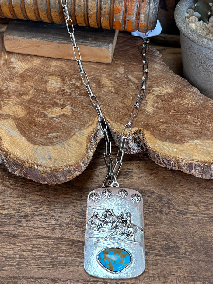 Silver-tone roping pendant necklace with turquoise-style oval centerpiece, chain