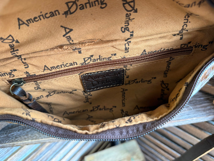 Tan interior lining with repeating American Daring print, zip pocket, and stitched seams