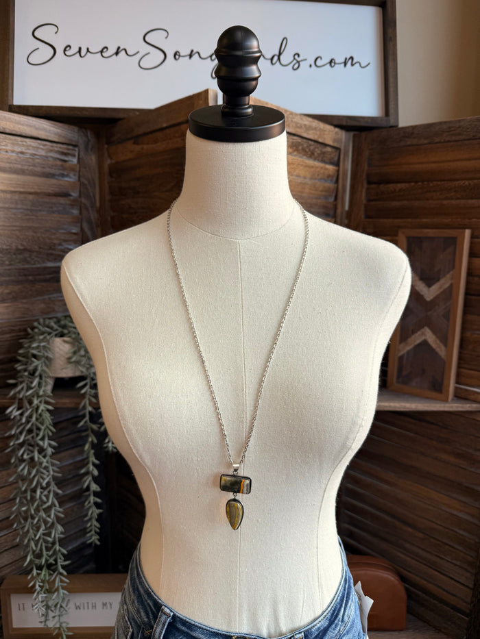 Silver-plated lariat necklace on mannequin with rectangular and teardrop bee jasper stones