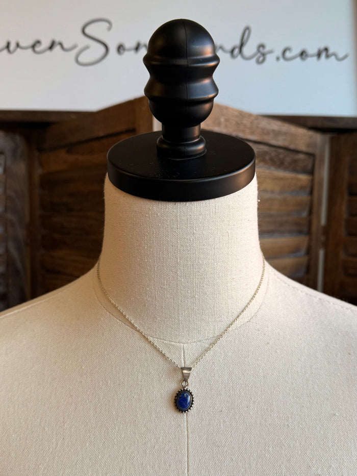 Silver necklace with lapis blue oval pendant on mannequin