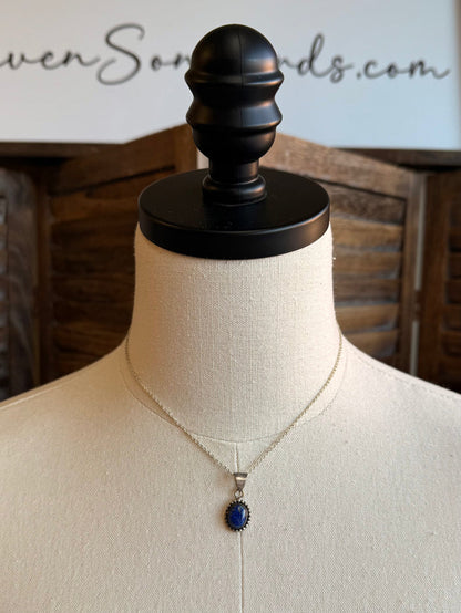 Silver necklace with lapis blue oval pendant on mannequin