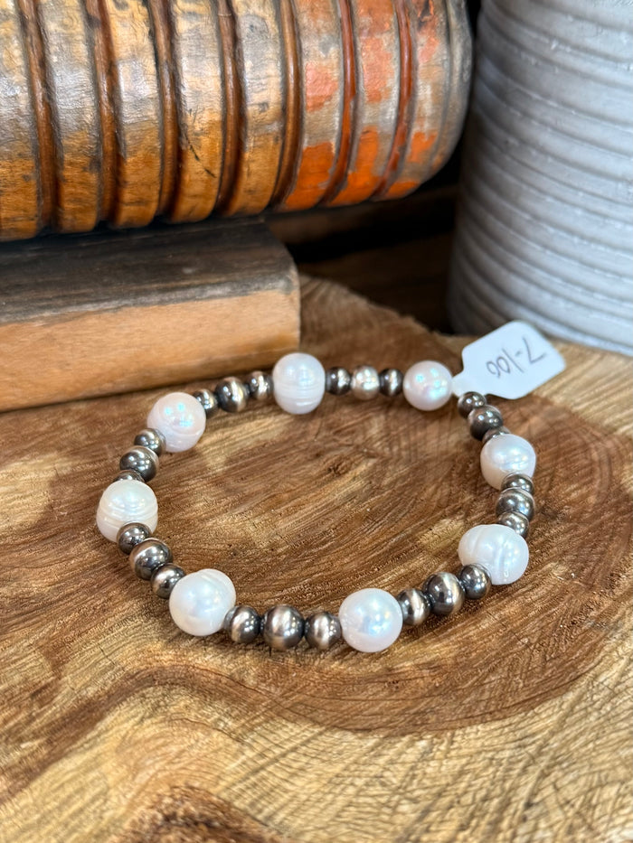 Stretchy freshwater pearl bracelet with white iridescent pearls and silver metal beads