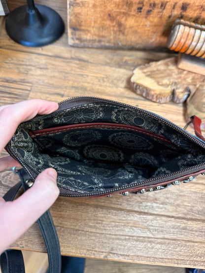 Interior view of navy leather crossbody purse showing patterned lining and zipper