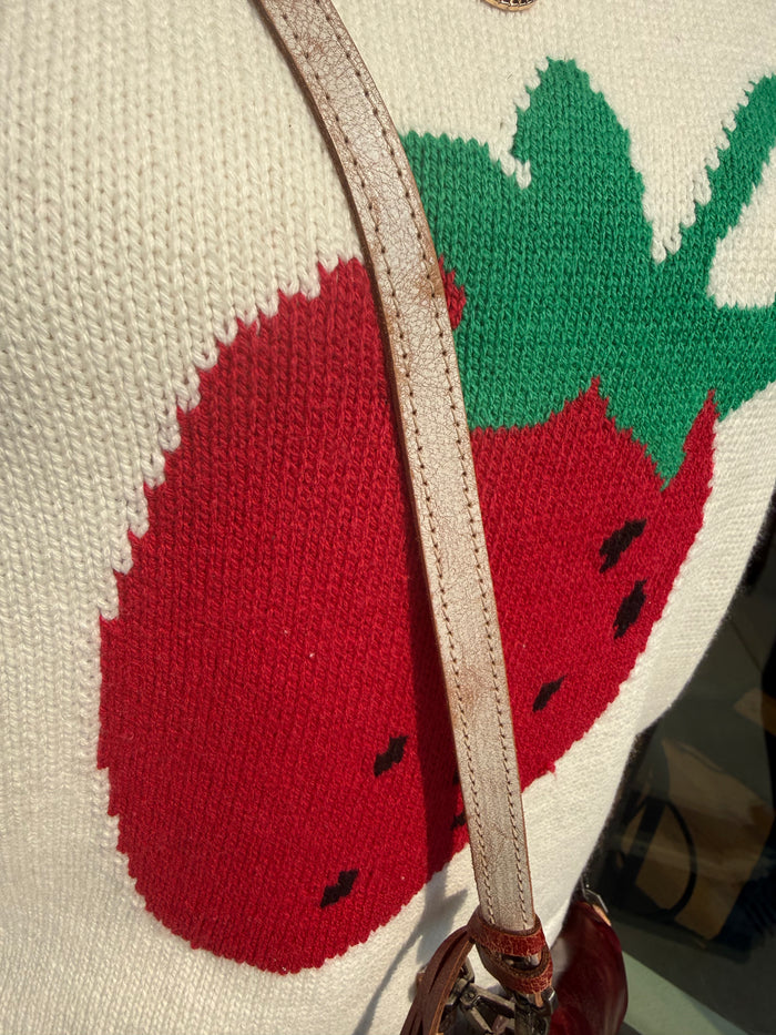 Cream knit short-sleeve sweater with large red strawberry motif and green tops