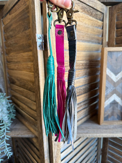 Colorful leather tassel clips in teal, fuchsia, and black with metal key rings