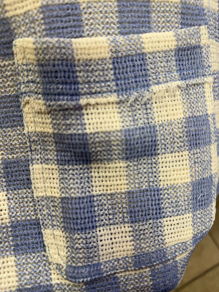 Blue and white checked shirt fabric close-up with textured woven pattern