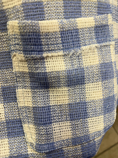 Blue and white checked shirt fabric close-up with textured woven pattern