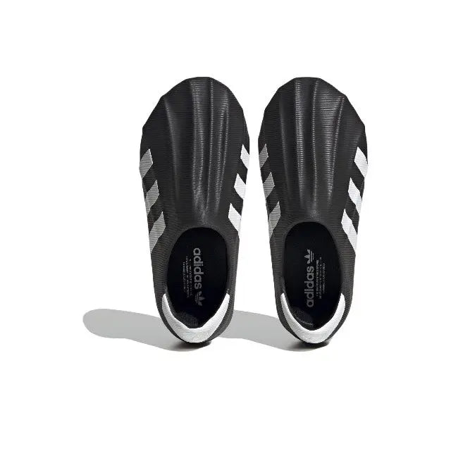Adidas Adifom black slip-on sneakers, inside view with white stripes