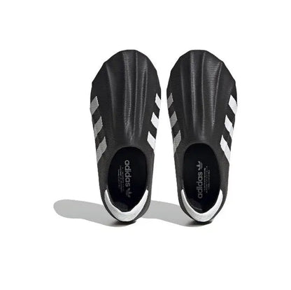 Adidas Adifom black slip-on sneakers, inside view with white stripes