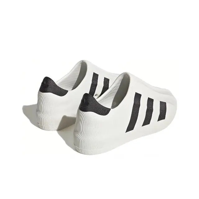 White slip-on sneaker showing heel with black accents and adidas stripes