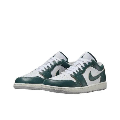 Low-top sneaker pair in white with dark green overlays and lace-up front