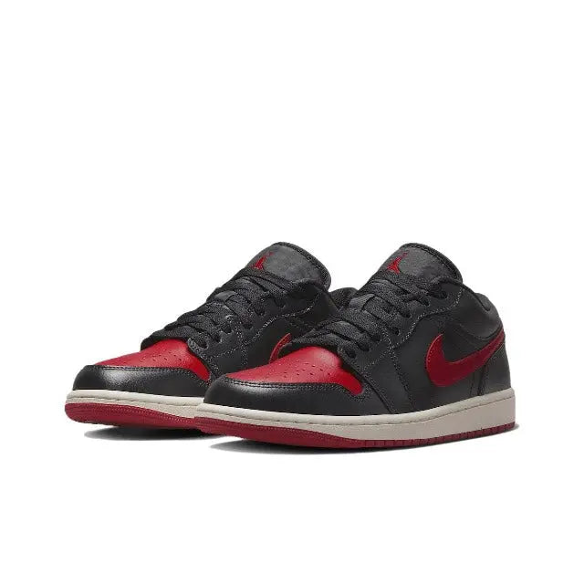 Air Jordan 1 sneakers pair, black uppers with red heel panels and white midsole
