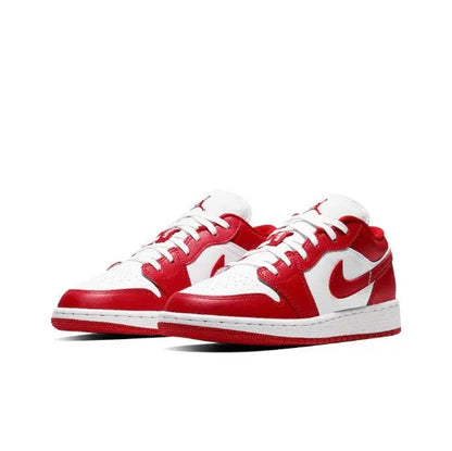 Low-top sneaker front view with red uppers, white toe, and Nike Swoosh