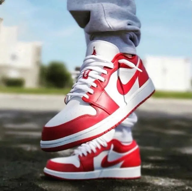 Red-and-white low-top sneaker on foot, showing side Nike logo and lace-up