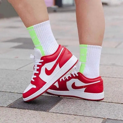 Red-and-white low-top sneakers with lace-up front, Nike Swoosh, and white midsole