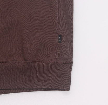 Fleece crewneck sweatshirt hem close-up with small Nike logo tag