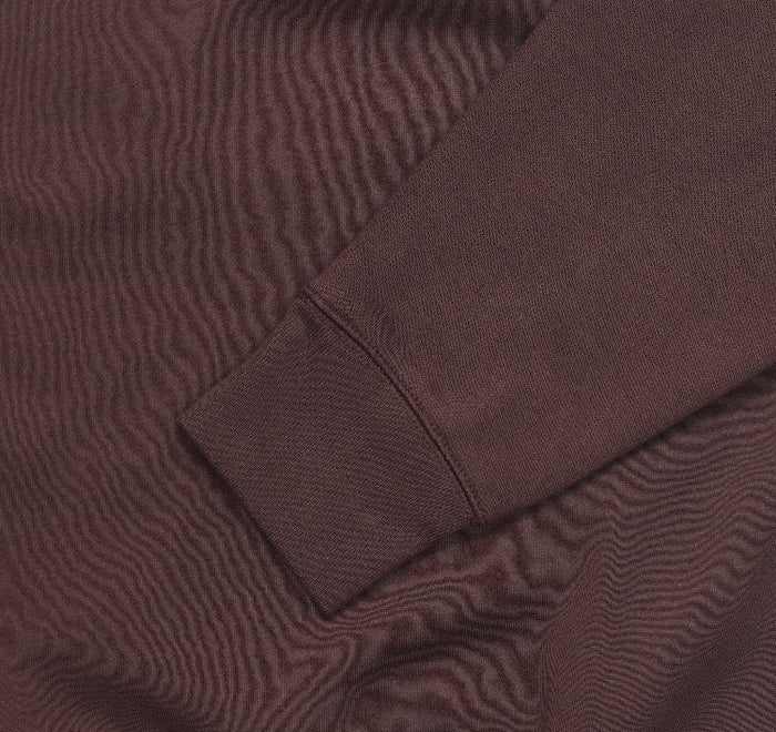 Fleece crewneck sweatshirt fabric and seam close-up in brown