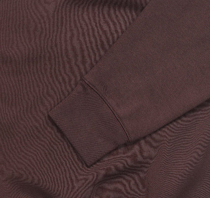 Fleece crewneck sweatshirt fabric and seam close-up in brown