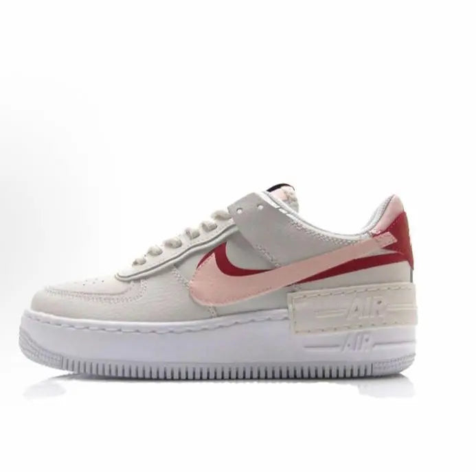 Nike low-top sneakers, light gray leather with red swoosh and pink side panels