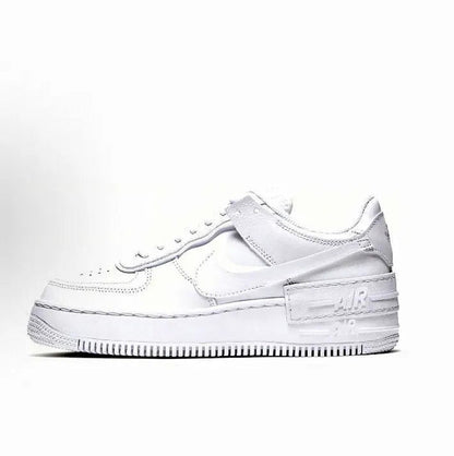 White low-top leather sneaker with Nike Swoosh, lace-up, perforated toe and rubber sole