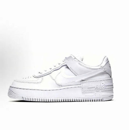 White low-top leather sneaker with Nike Swoosh, lace-up, perforated toe and rubber sole