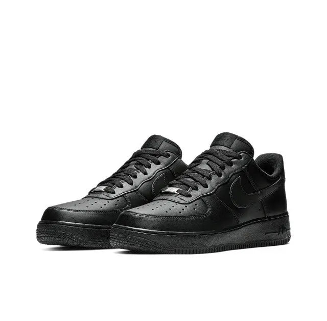 Black low-top sneaker pair, side view with lace-up, toe perforations and swoosh