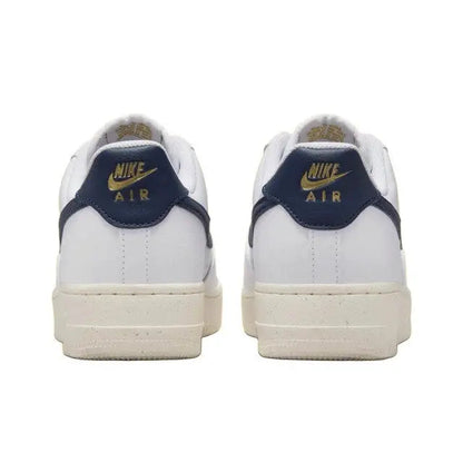 Nike Air Force 1 low-top sneakers with navy heel tab, gold Air logo, and white uppers