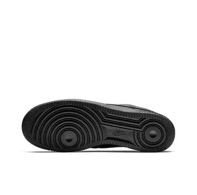 Black low-top sneaker outsole with textured rubber tread and circular traction pods