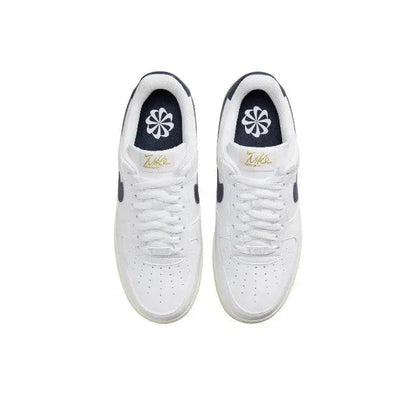 Nike Air Force 1 low-top sneakers pair, white laces with navy tongue and gold heel mark