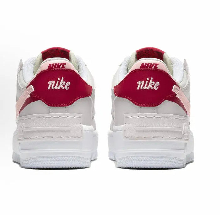 Nike low-top sneakers, light gray with red heel tab and white midsole