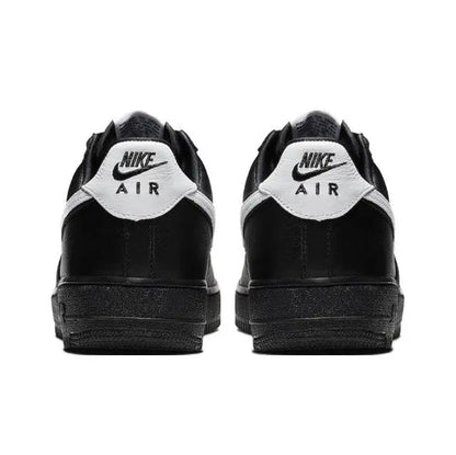 Black low-top sneakers with white heel label and rear padding