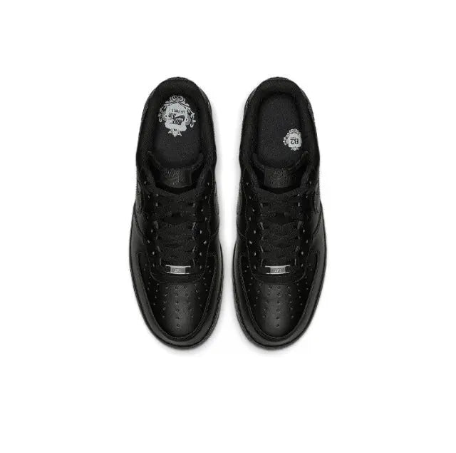 Black low-top sneaker pair, top view with laces, perforated toe and lace eyelets